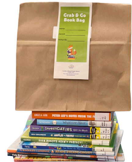 Kraft paper bag with Grab and Go form attached sitting atop a stack of children's picture books.