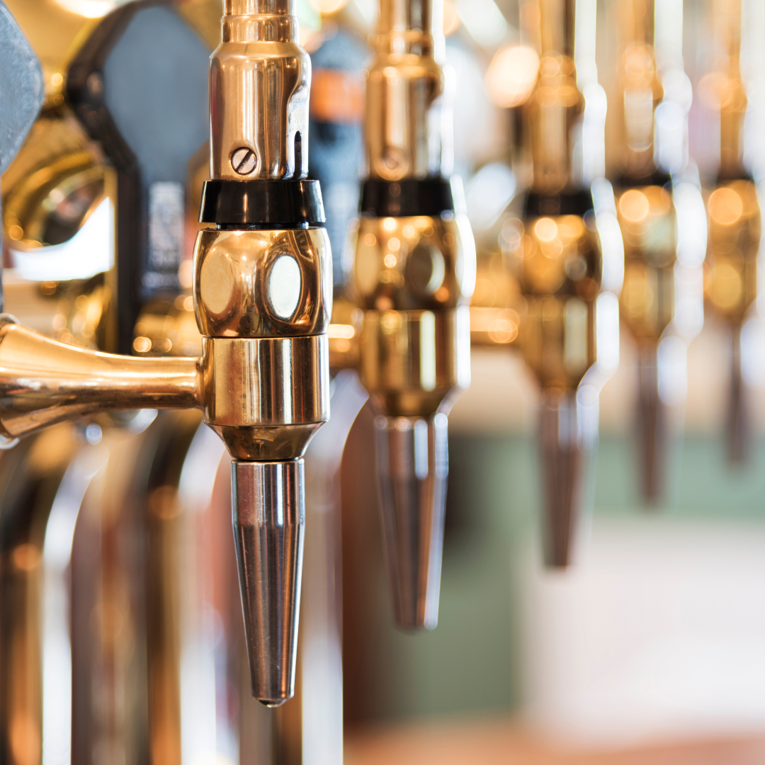 Copper-coloured beer taps in a row.