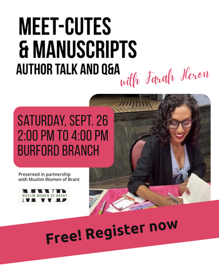 a woman smiles and autographs a book